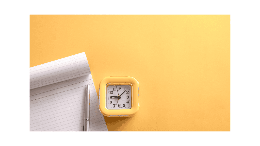 Yellow background, with white notepad and a yellow clock.